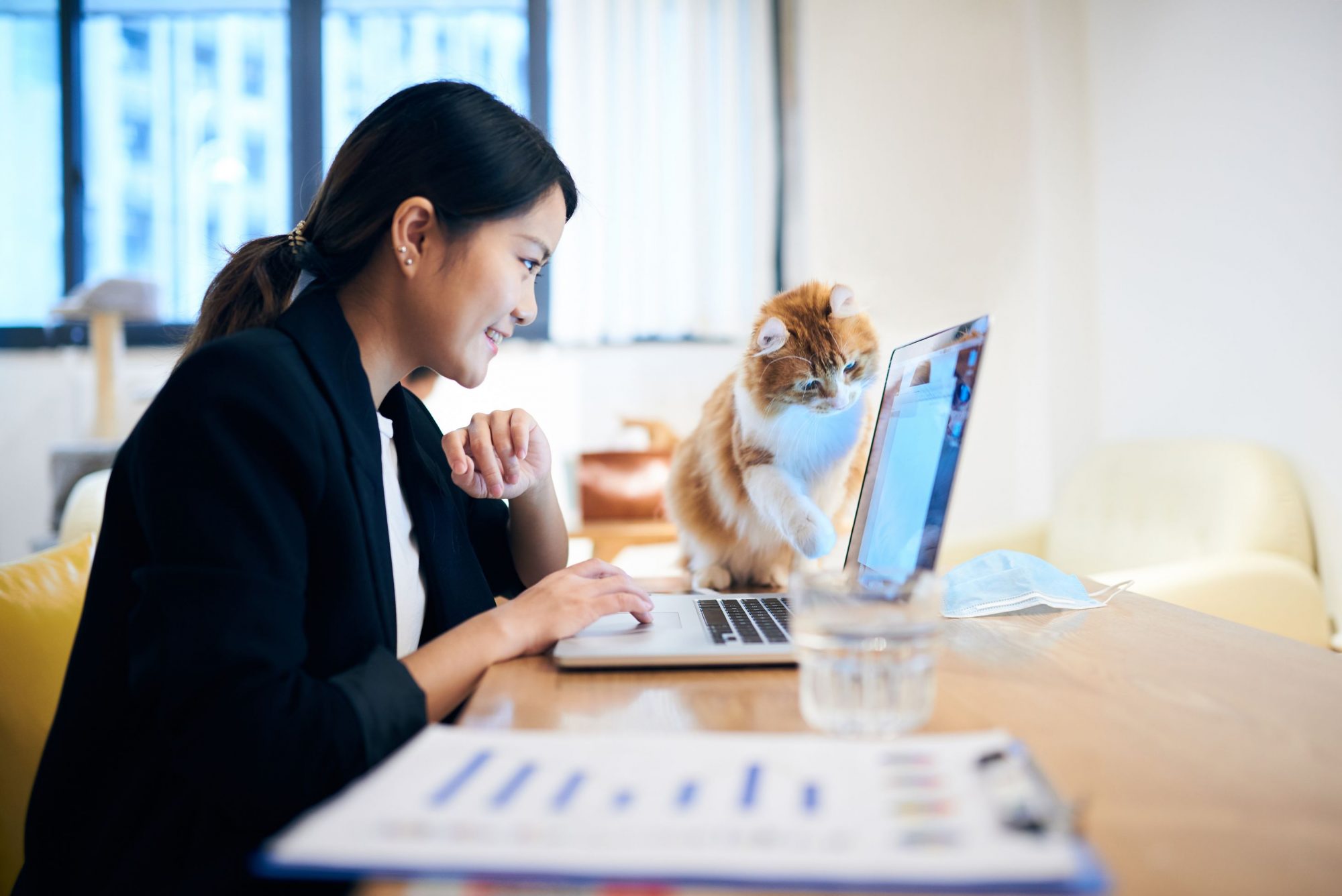 A dog with her human visiting the office for Take Your Pet to Work Week.