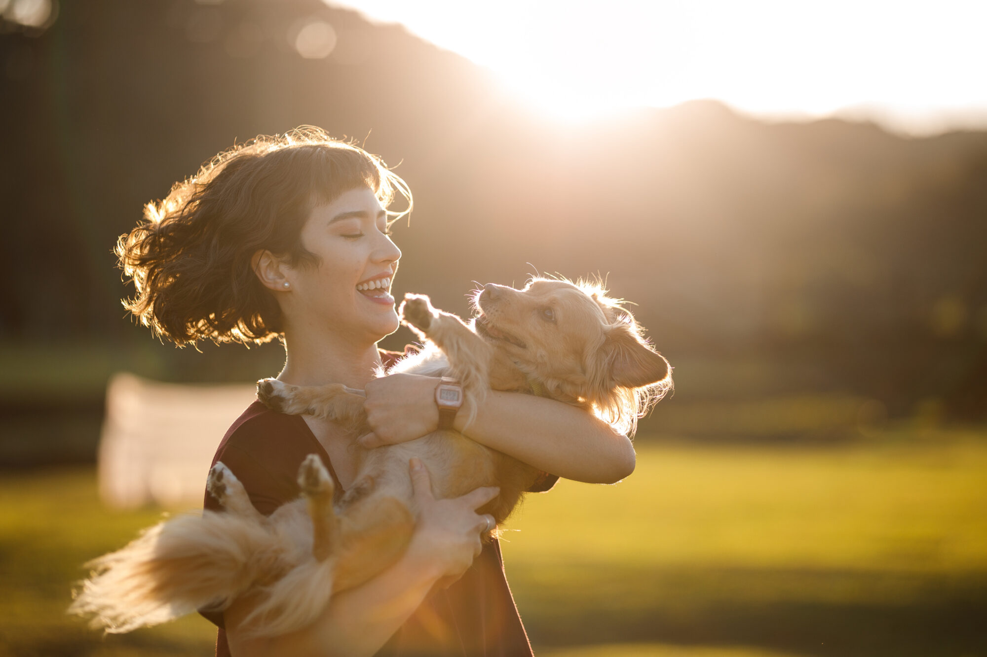 Woman holding dog.